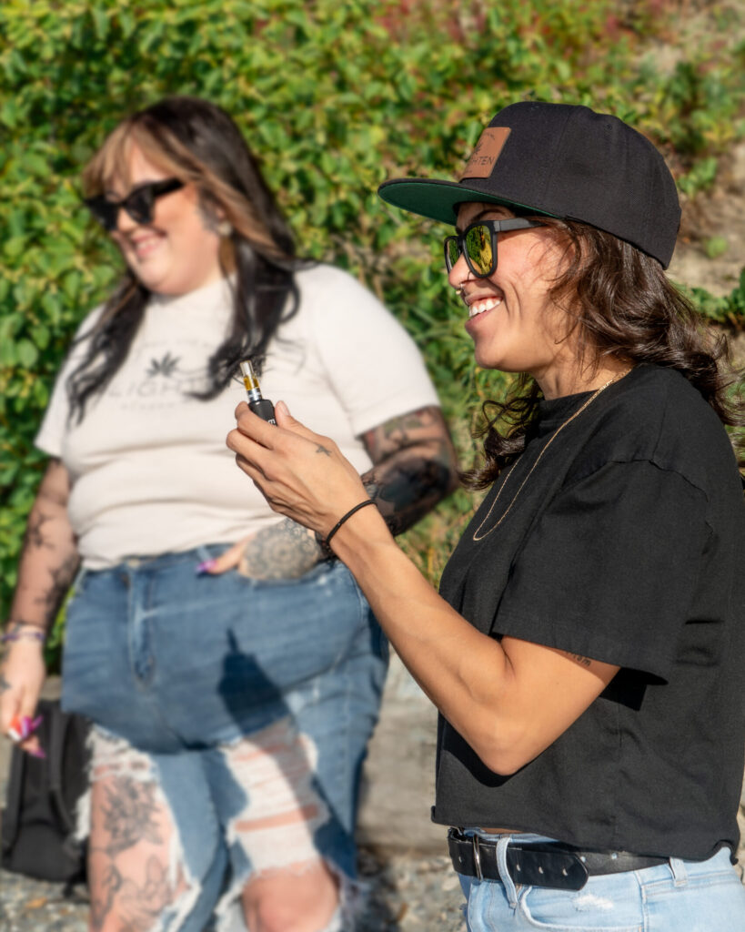 Friends smoking a terp sauce vape cart in Anchorage from Enlighten Alaska's product line