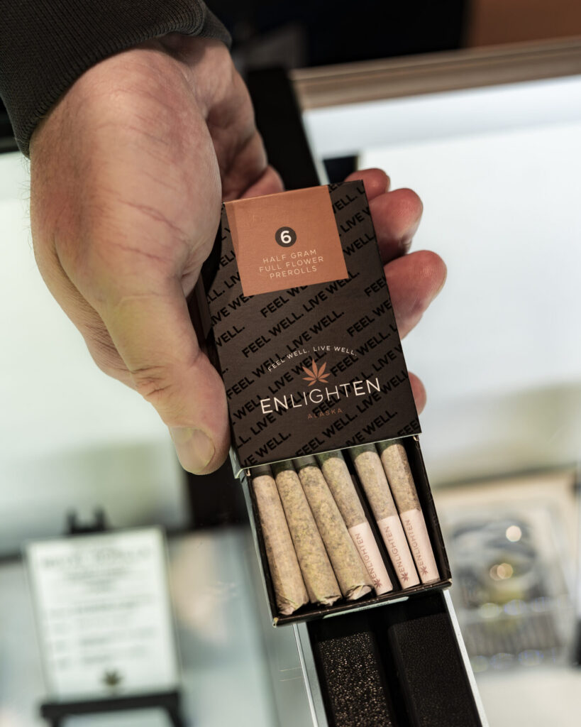 Enlighten Alaska half-gram full flower preroll 6-pack held open showing six hand-rolled joints in branded packaging