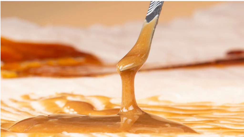 Cannabis budder concentrate with a soft, opaque, frosting-like texture created by whipping cannabis extract.