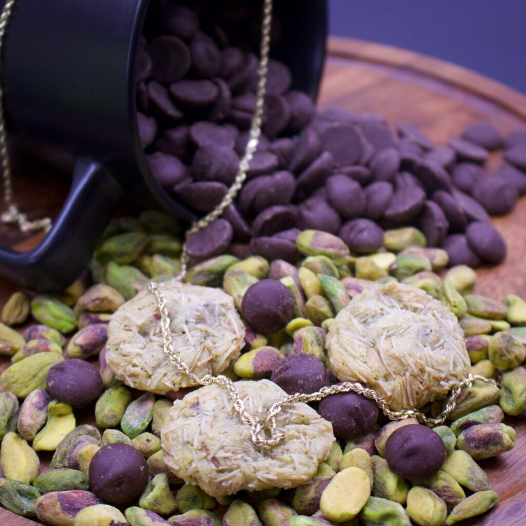 Enlighten Alaska's Dubai Chocolate Cookies on a bed of pistachios and chocolate chips