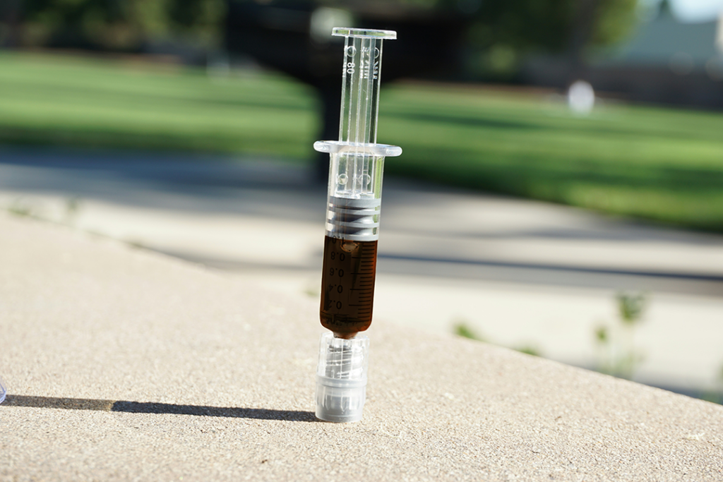 Full Extract Cannabis Oil (FECO) also known as RSO in a syringe applicator, a versatile activated cannabis concentrate for ingesting or topical use